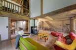 Discover rustic charm in this stunning property, featuring exposed wooden beams and a cozy fireplace.