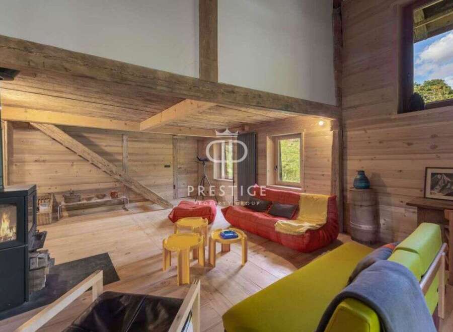 Experience rustic charm in this stunning property, featuring warm wooden interiors and a cozy fireplace.