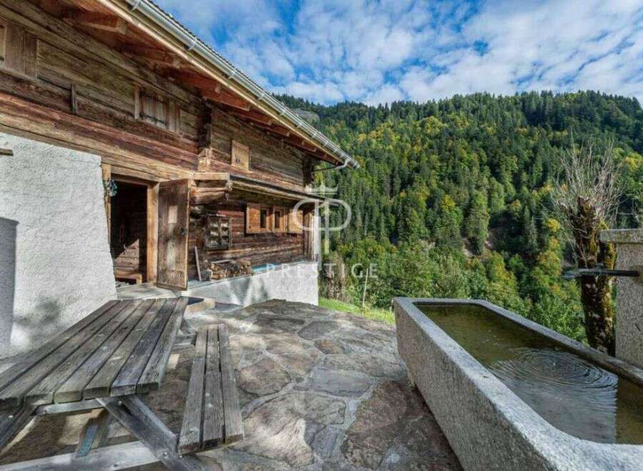 Discover the charm of this rustic wooden cabin nestled in a serene mountain setting.