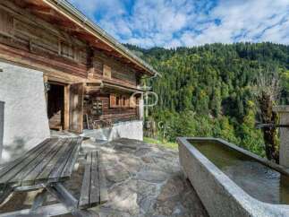 Discover the charm of this rustic wooden cabin nestled in a serene mountain setting.