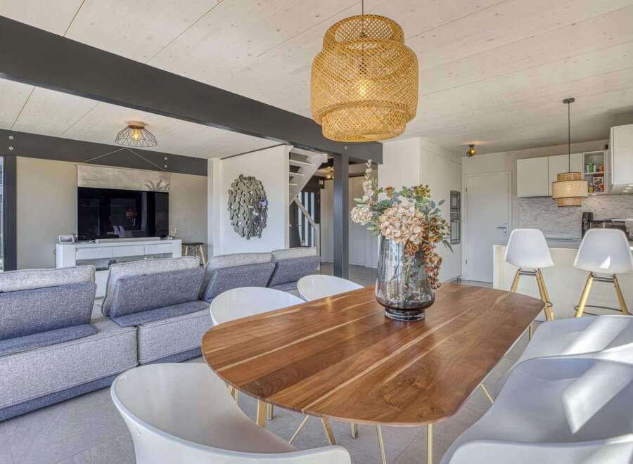 Stunning open-plan living space featuring a sleek modern kitchen and a cozy living area with comfortable seating.