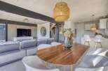 Stunning open-plan living space featuring a sleek modern kitchen and a cozy living area with comfortable seating.
