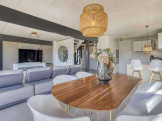 Stunning open-plan living space featuring a sleek modern kitchen and a cozy living area with comfortable seating.