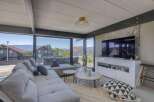 Modern living room with floor-to-ceiling windows offering scenic views.
