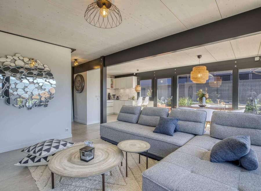 Stunning open-plan living space with modern gray sectional sofa and stylish decor.
