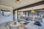 Stunning open-plan living space with modern gray sectional sofa and stylish decor.