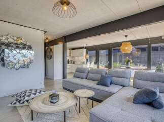 Stunning open-plan living space with modern gray sectional sofa and stylish decor.