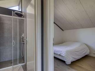 This stunning property boasts a modern ensuite bathroom with a spacious shower, perfect for relaxing after a long day.