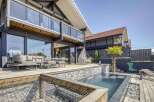 Luxury waterfront home with private infinity pool and expansive deck.