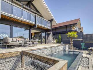 Luxury waterfront home with private infinity pool and expansive deck.