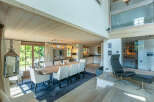 This stunning chalet boasts a spacious open-plan living area with a large dining table perfect for family gatherings.