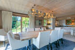 This stunning chalet boasts a spacious dining area with a large wooden table, perfect for family gatherings.
