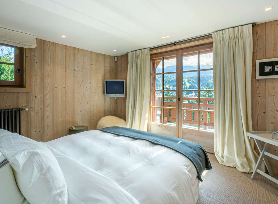 Wake up to breathtaking mountain views from this luxurious bedroom.