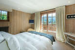 Wake up to breathtaking mountain views from this luxurious bedroom.