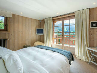 Wake up to breathtaking mountain views from this luxurious bedroom.