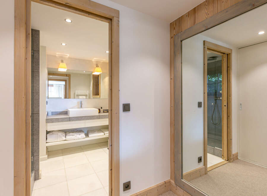 This stunning bathroom boasts a modern design with a sleek white sink and plenty of storage.