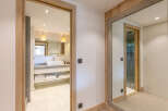 This stunning bathroom boasts a modern design with a sleek white sink and plenty of storage.