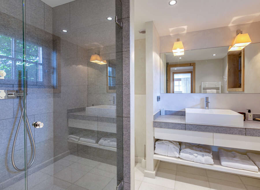 Luxurious bathroom with a spacious walk-in shower and modern vanity.