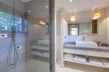 Luxurious bathroom with a spacious walk-in shower and modern vanity.