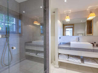 Luxurious bathroom with a spacious walk-in shower and modern vanity.