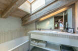 This stunning bathroom boasts a unique blend of rustic charm and modern amenities.