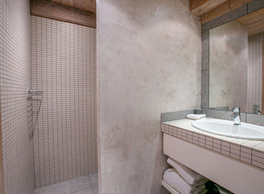 This stunning bathroom boasts a modern design with a sleek sink and shower.