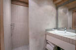 This stunning bathroom boasts a modern design with a sleek sink and shower.