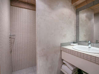 This stunning bathroom boasts a modern design with a sleek sink and shower.