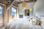 Wake up to breathtaking mountain views from this luxurious bedroom.