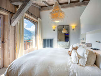 Wake up to breathtaking mountain views from this luxurious bedroom.