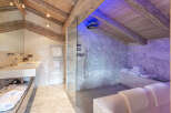 Luxurious bathroom with marble finishes and a spacious glass-enclosed shower.
