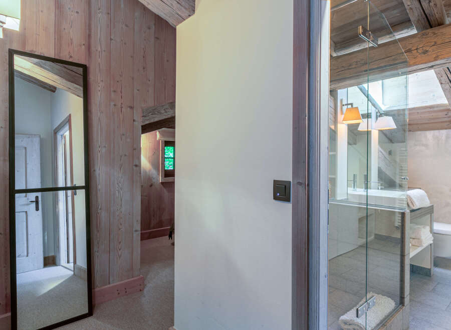 This stunning property boasts a luxurious bathroom with a glass-enclosed shower and modern fixtures.