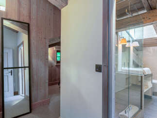This stunning property boasts a luxurious bathroom with a glass-enclosed shower and modern fixtures.