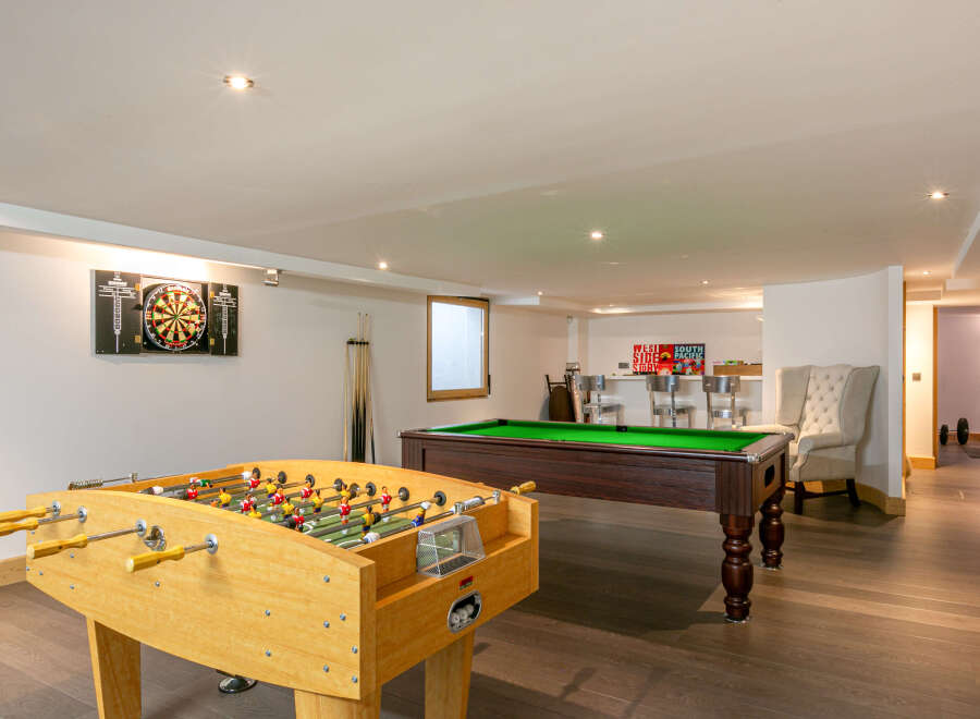 This stunning property boasts a fantastic games room, perfect for entertaining guests or enjoying some friendly competition.