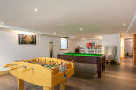 This stunning property boasts a fantastic games room, perfect for entertaining guests or enjoying some friendly competition.