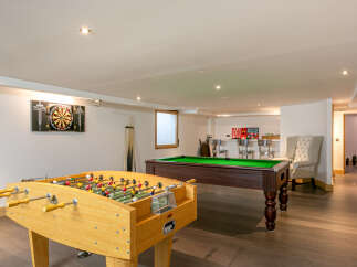 This stunning property boasts a fantastic games room, perfect for entertaining guests or enjoying some friendly competition.