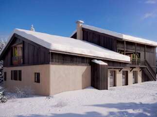 This stunning chalet boasts a unique blend of modern and rustic design, featuring a spacious layout and large windows that offer breathtaking views.