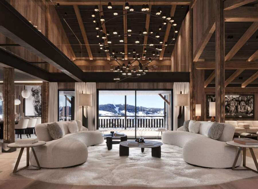 This luxurious chalet boasts a stunning open-plan living area with floor-to-ceiling windows offering breathtaking mountain views.