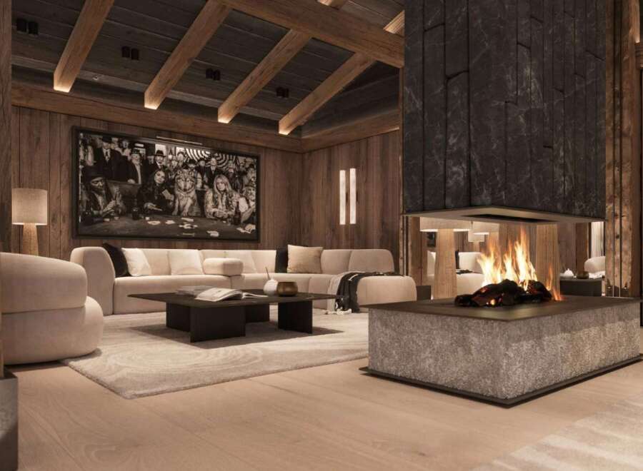 This luxurious chalet boasts a stunning centerpiece: a large, modern fireplace with a rustic stone surround, creating a warm and inviting atmosphere.