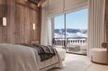 Wake up to breathtaking mountain views from this luxurious bedroom.