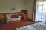 Cozy hotel room featuring a comfortable sofa and a well-appointed desk area.