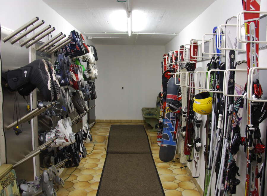 This ski storage room offers a convenient and organized space for storing your equipment.