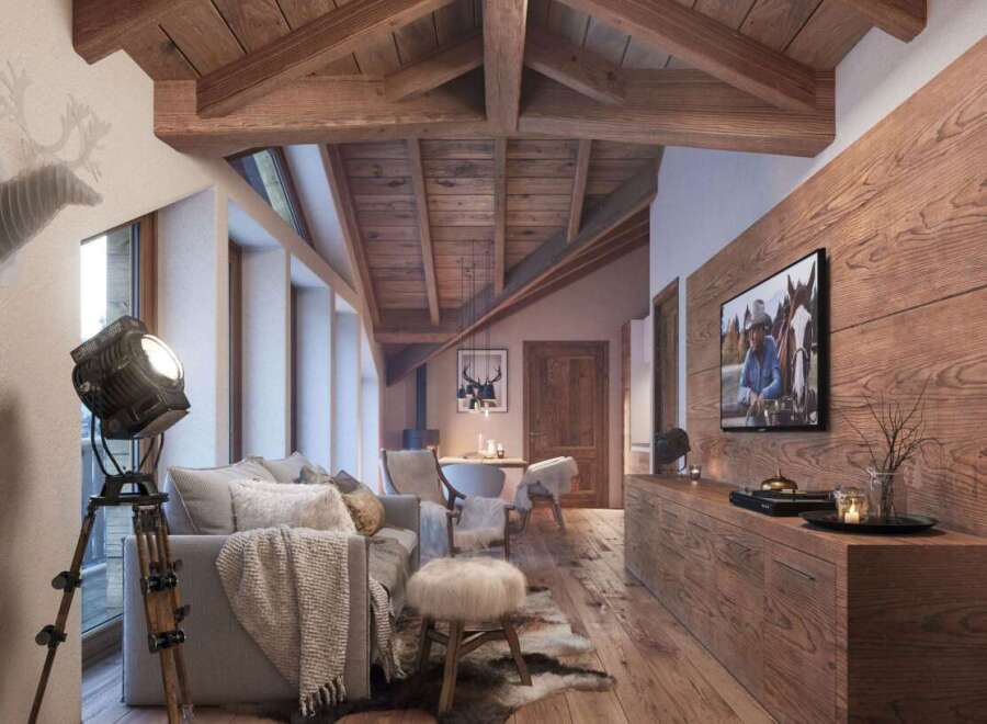 Rustic mountain chalet with exposed wooden beams, large windows offering stunning views, and a cozy living area featuring a comfortable sofa and sheepskin rug.