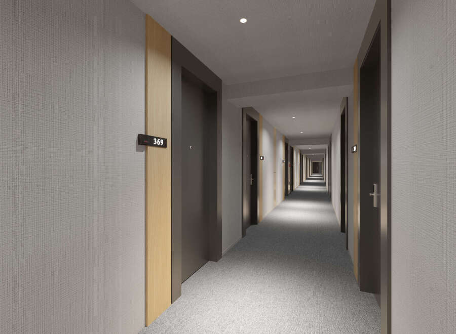 This hotel boasts a modern and minimalist hallway design, featuring sleek dark doors accented with light wood trim.