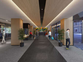 This hotel boasts a modern and spacious lobby with a sleek design, featuring a long hallway with a dark grey tiled floor and wood paneled ceiling.