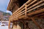 This stunning chalet boasts a rustic-chic design, featuring exposed wooden beams and a stone exterior.
