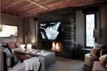 Luxurious chalet featuring a stunning marble fireplace, large screen TV, and comfortable seating area.