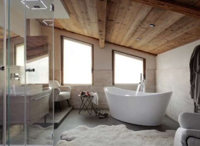 Luxurious bathroom with a freestanding bathtub and wooden ceiling.