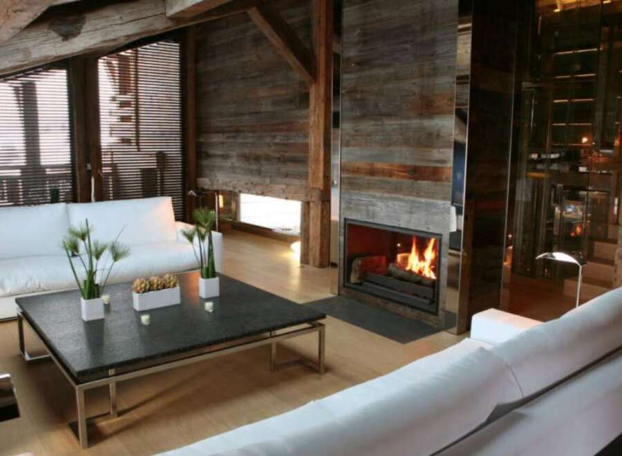 Rustic-chic living room with reclaimed wood walls and exposed beams.