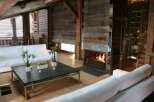 Rustic-chic living room with reclaimed wood walls and exposed beams.